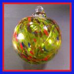 Witch Ball4: WB33 Red, Green and Purple with a somewhat rough surface on a green background, 4 inches, 2 for $18